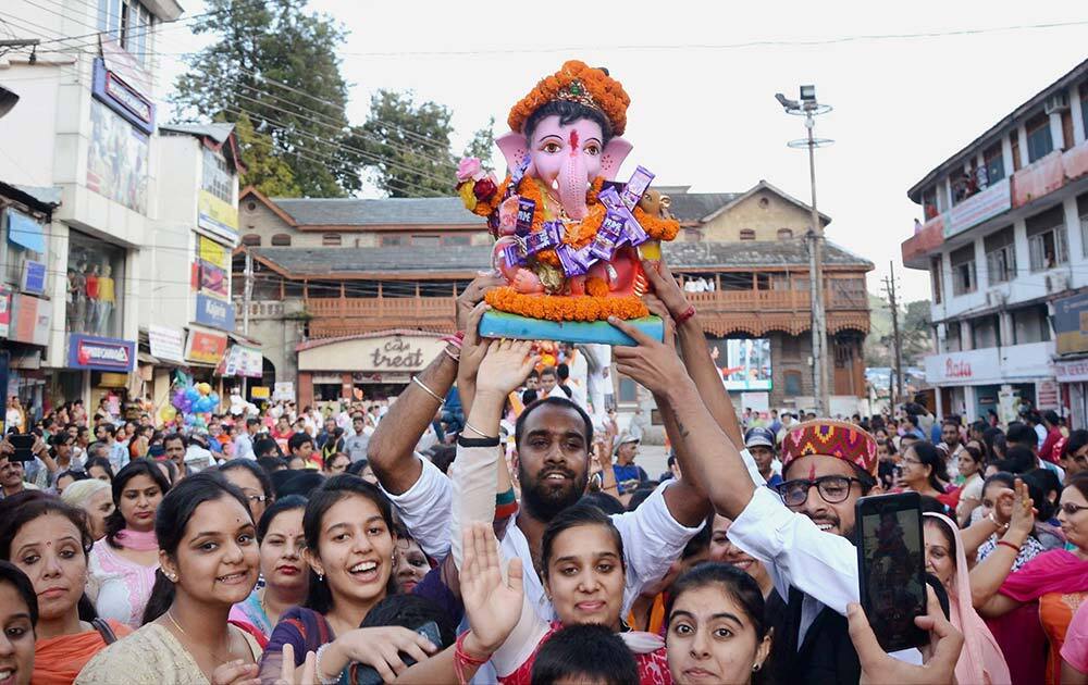 Devotees take out a holy procession on the concluding of Ganeshotsav