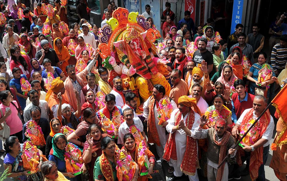 Devotees carry an idol of Lord Ganesh for immersion in a river on the outskirts of Shimla