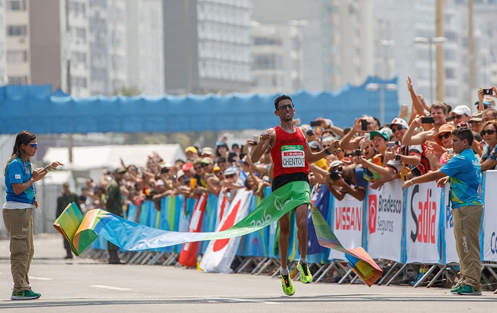 El Amin Chentouf, of Morocco, crosses the finish line to win the gold medal in the mens T12 Marathon at Fort Copacabana