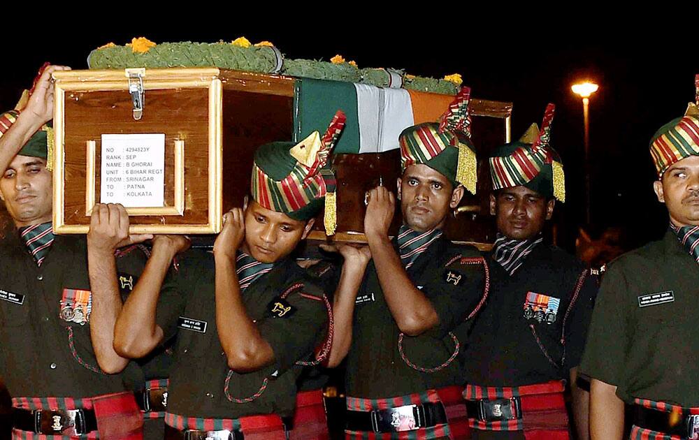 Army jawans carry the body of Sep B Ghorai who was killed in Uri attack
