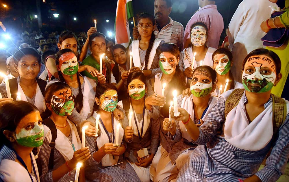 Students during candle light vigil, pray for Indian soldiers, who were killed in a terror attack at an army base 