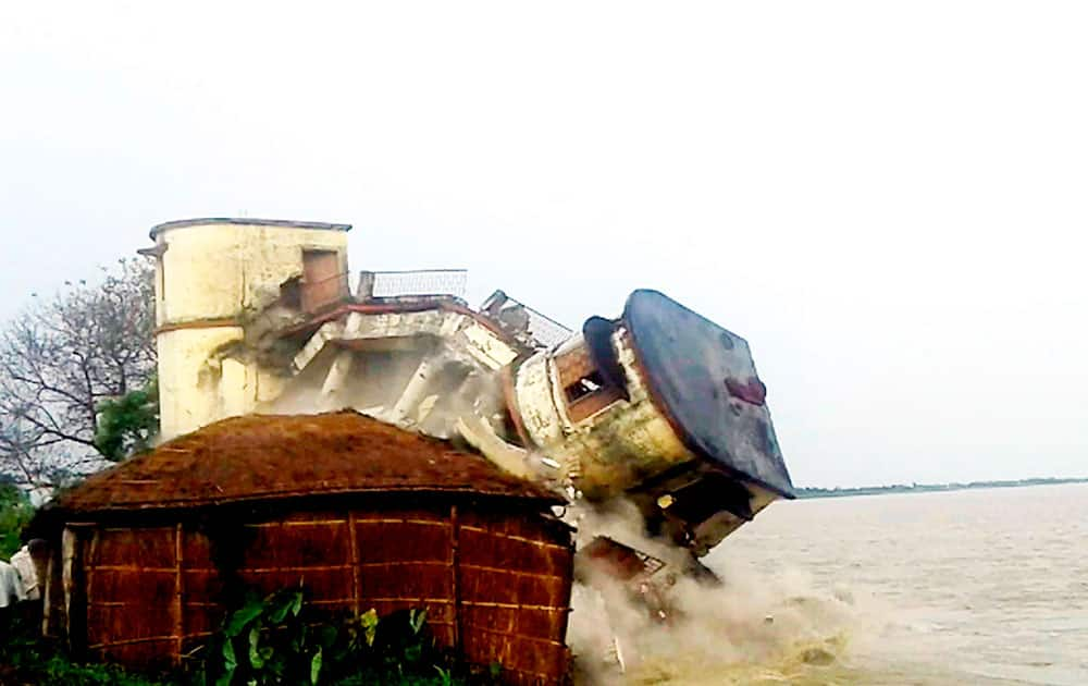 A part of the Kisan Bhawan Panchayat office collapses due to erosion at the banks of Gandak river