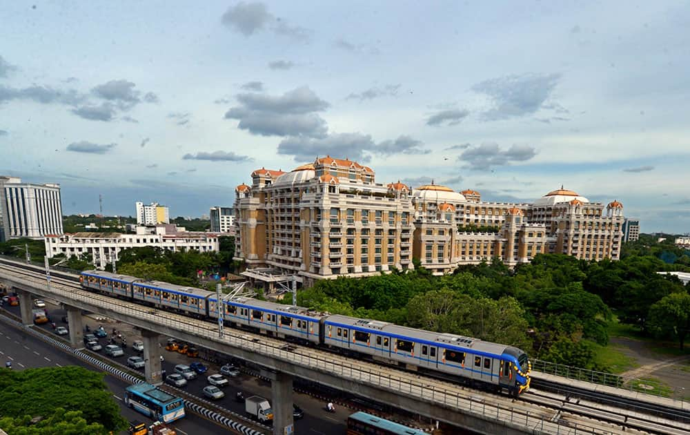 A Chennai Metro Rail train runs on the tracks between the Airport and Little Mount