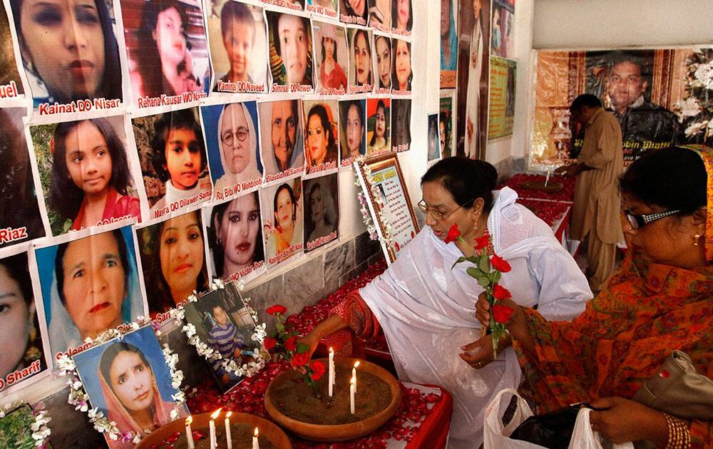 People pay tribute to victims of a 2013 suicide attack on a church