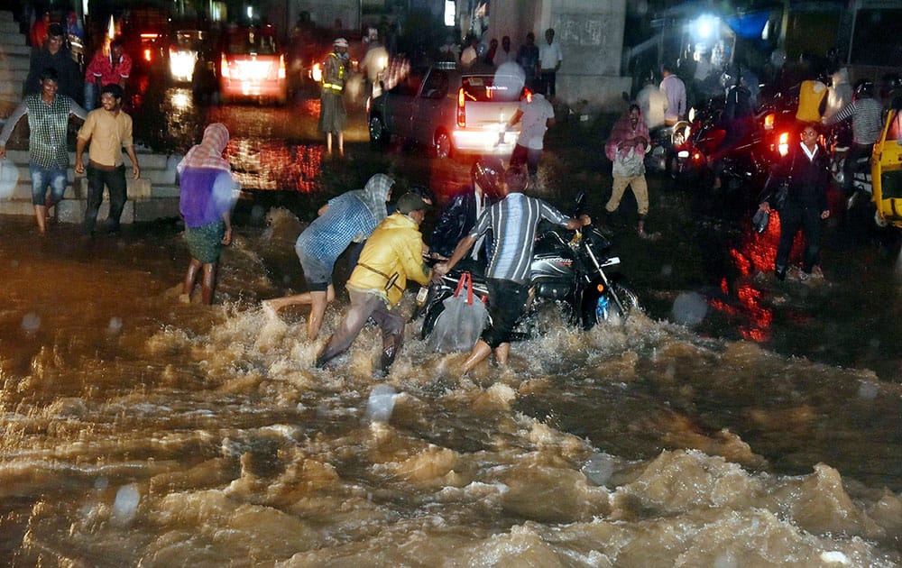 Flooded streets after heavy rain two wheelers washed away near Mahboob Mansion Market Malakpet in Hyderabad