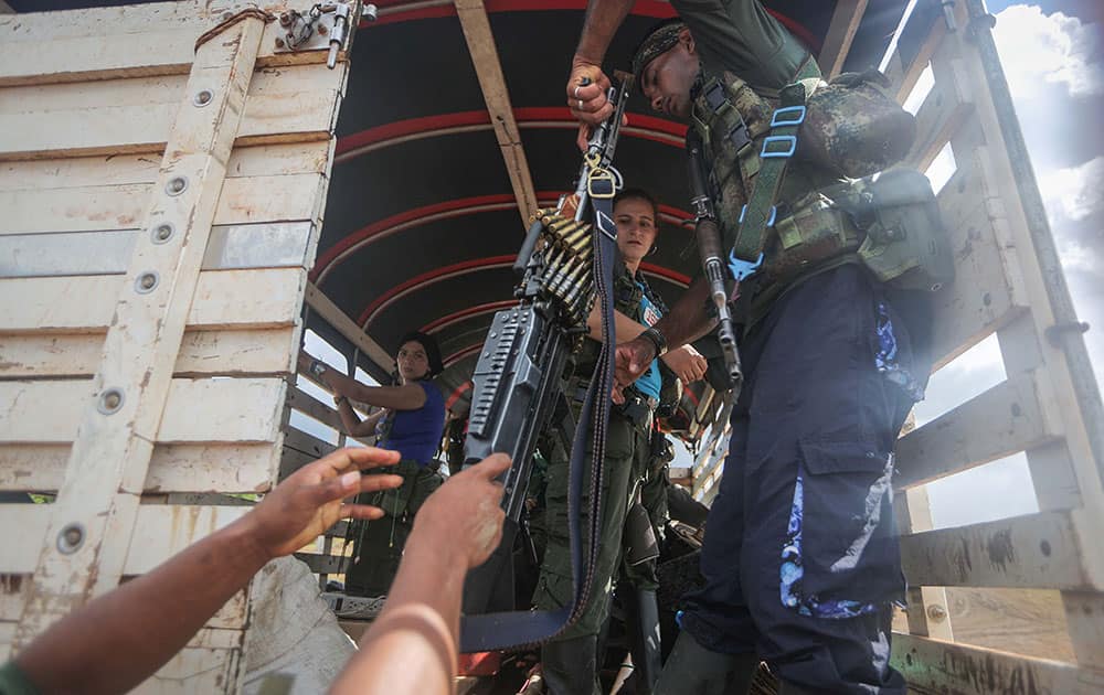  Revolutionary Armed Forces of Colombia (FARC) rebels depart their camp with their weapons