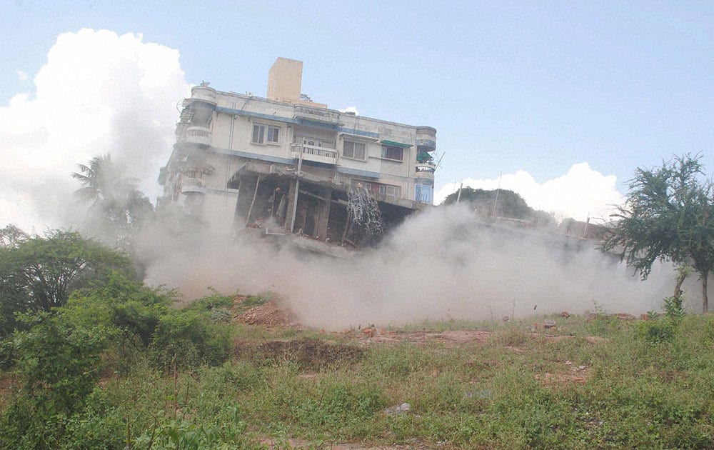 An illegally constructed double-storeyed building is blasted off with dynamite by Municipal Corporations anti encroachment squad
