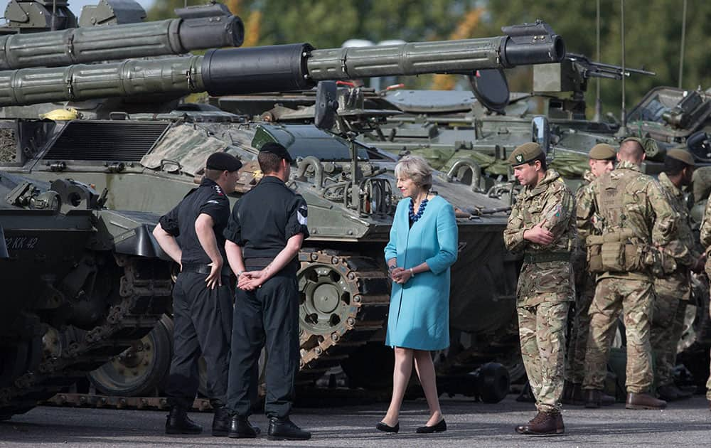 Britains Prime Minister, Theresa May, centre, greets troops as she visits 1st Battalion The Mercian Regiment at their barracks at Bulford Camp near Salisbury