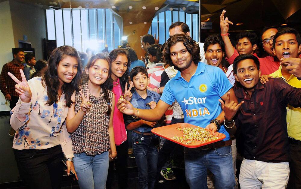 Youths cheer as they enjoy the first day show of M.S Dhoni: The Untold Story film at a theatre in Ranchi