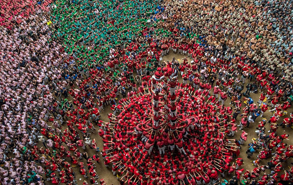 Members of the colla 'Colla Jove Xiquets de Valls' climb up as they construct a human tower during the 26th Tarragona Competition