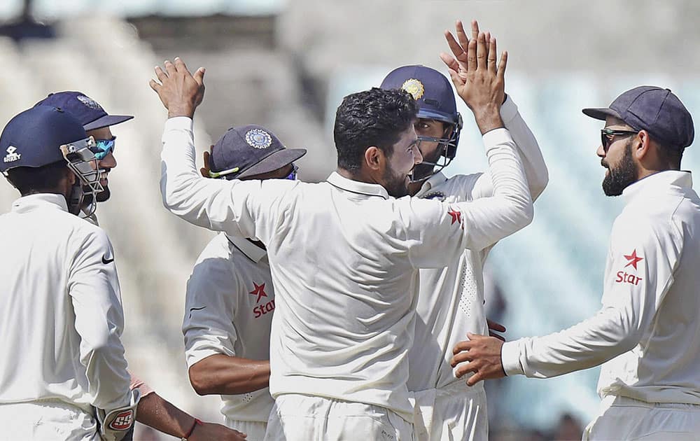 Indian players celebrate the fall of a wicket on the fourth day of the second Test match against New Zealand at Eden Garden in Kolkata