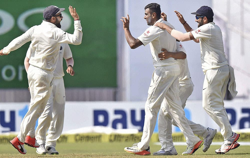 Indian players celebrate the fall of a wicket on the fourth day of the second Test match against New Zealand at Eden Garden in Kolkata