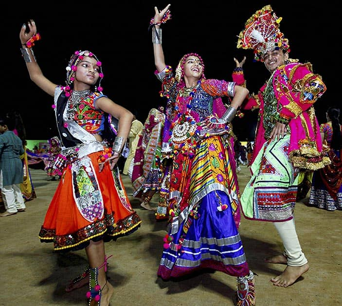 Artists in traditional attire perform Garba