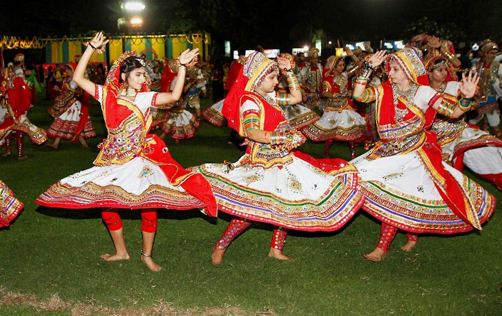 Participants dressed in traditional attire perform Garba