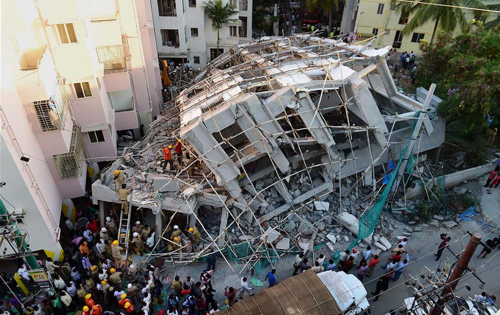 NDRF personnel carry out the rescue work after an under construction building collapsed at Belandur in Bengaluru