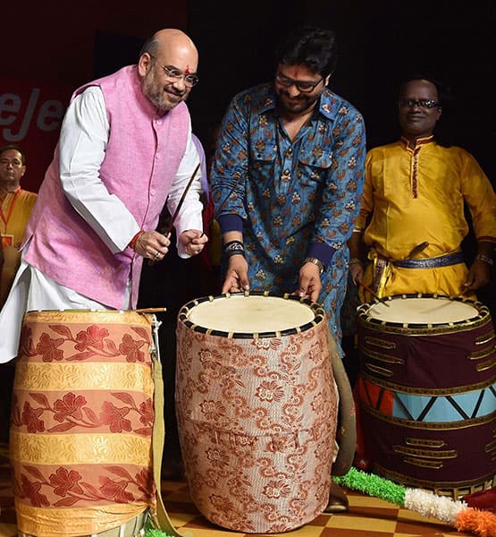 BJP President Amit Shah and Union Minister Babul Supriyo beat the drum during the inauguration of the Durga Puja Pandal at Safdarjung Enclave