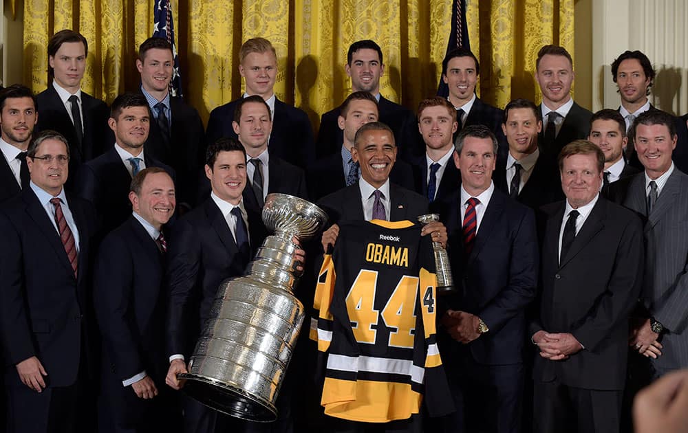 President Barack Obama poses with the 2016 Stanley Cup champion Pittsburgh Penguins during a ceremony in the East Room of the White House