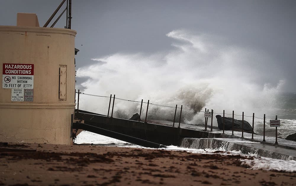 Waves crash ashore as Hurricane Matthew approaches the area in Singer Island, Florida