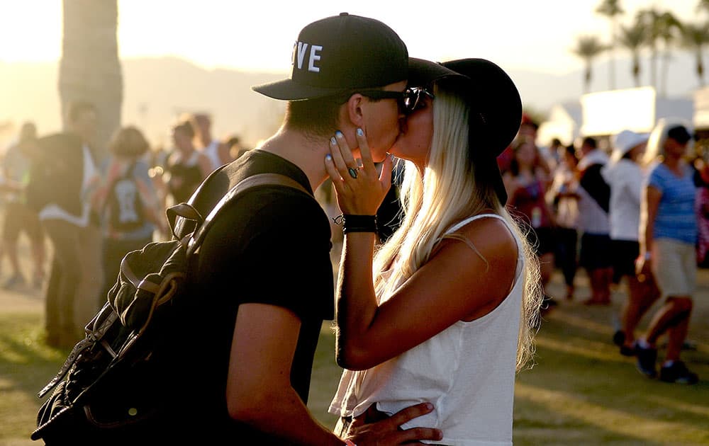 Music fans kiss during the sunset at Desert Trip at the Empire Polo Field in Indio, California Music fans kiss during the sunset at Desert Trip at the Empire Polo Field in Indio, California