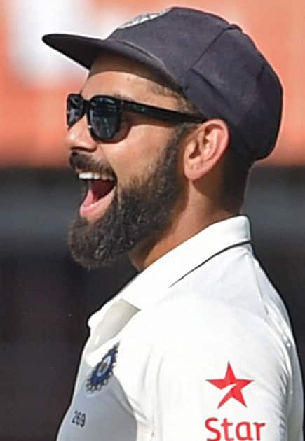 Indian captain Virat Kohli celebrates the wicket of New Zealand batsman Mitchell Santner during the third test match in Indore.