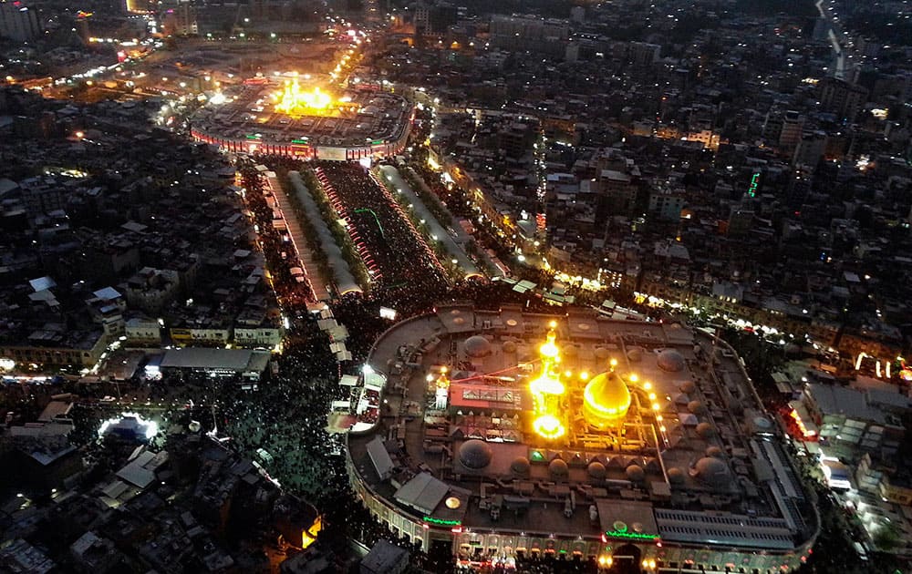 This aerial photo shows Shiite faithful pilgrims gathering between the holy shrine of Imam Hussein, top, and the holy shrine of Imam Abbas, bottom, during the Muslim month of Muharram