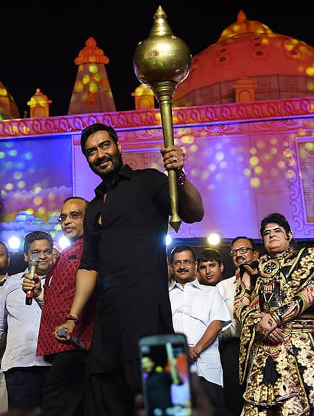 Actor Ajay Devgn holds a mace during Dussehra celebrations of Luv Kush Ramlila Committee Committee at Red Fort