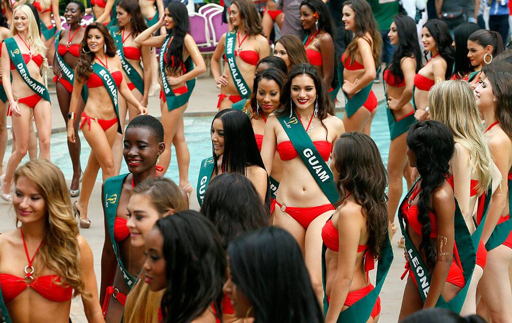 Beauty contestants for the Miss Earth 2016 international beauty pageant pose by the poolside of a hotel during their media presentation, in Manila