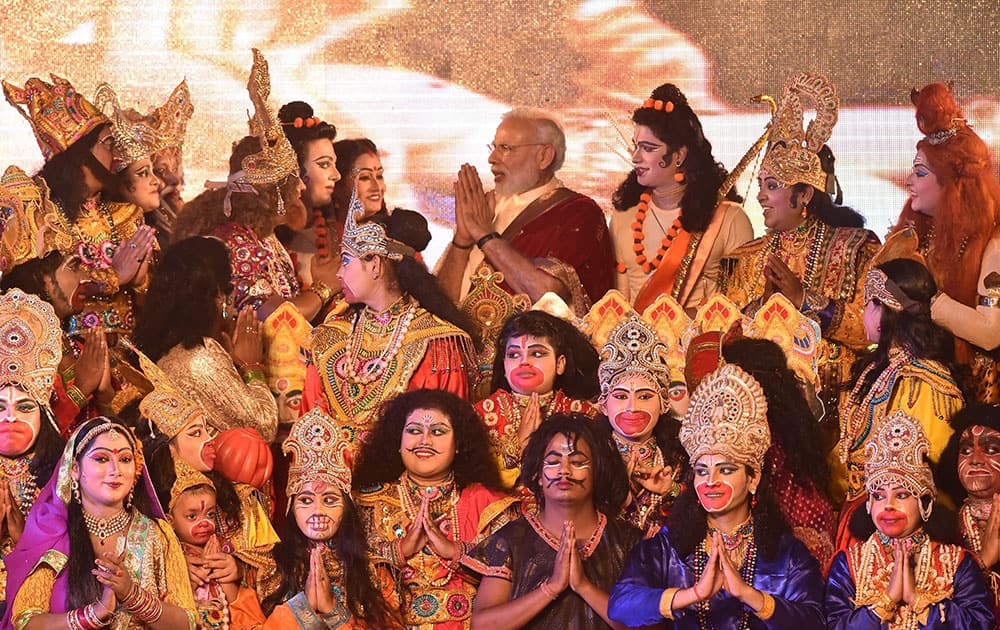 Prime Minister Narendra Modi interacts with the artists during Dussehra celebrations at Aishbagh Ram Leela in Lucknow