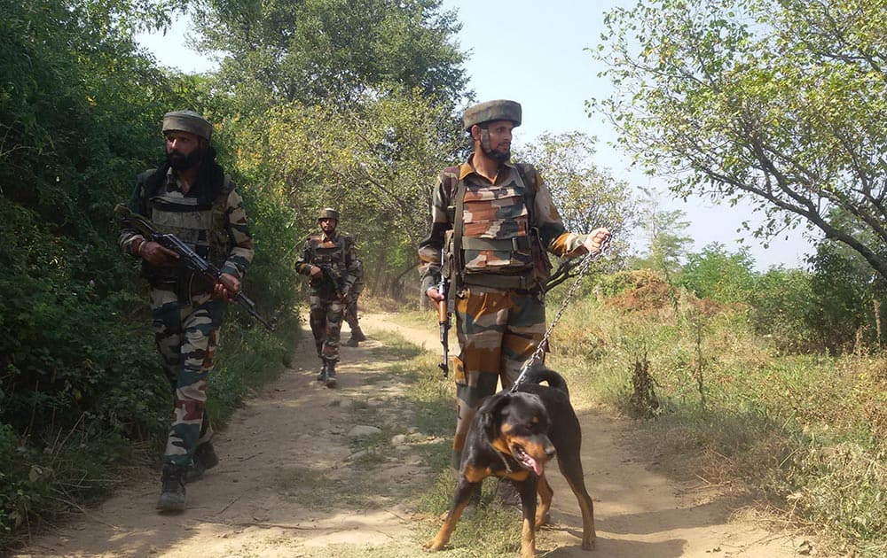 Sandy, a rottweiler on the prowl of militants with his uniformed colleague