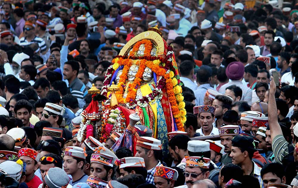 Devotees carrying idol in a procession taken out on the occasion of International festival of Kullu Dussehra in Kullu