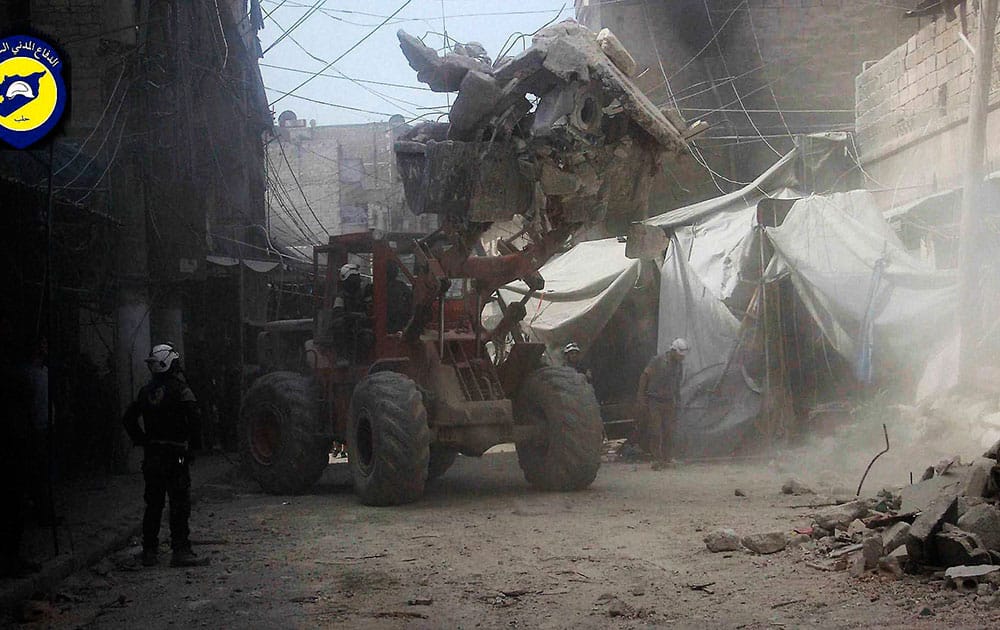 In this picture provided by the Syrian Civil Defense group known as the White Helmets, Syrian Civil Defense workers search through the rubble in rebel-held eastern Aleppo