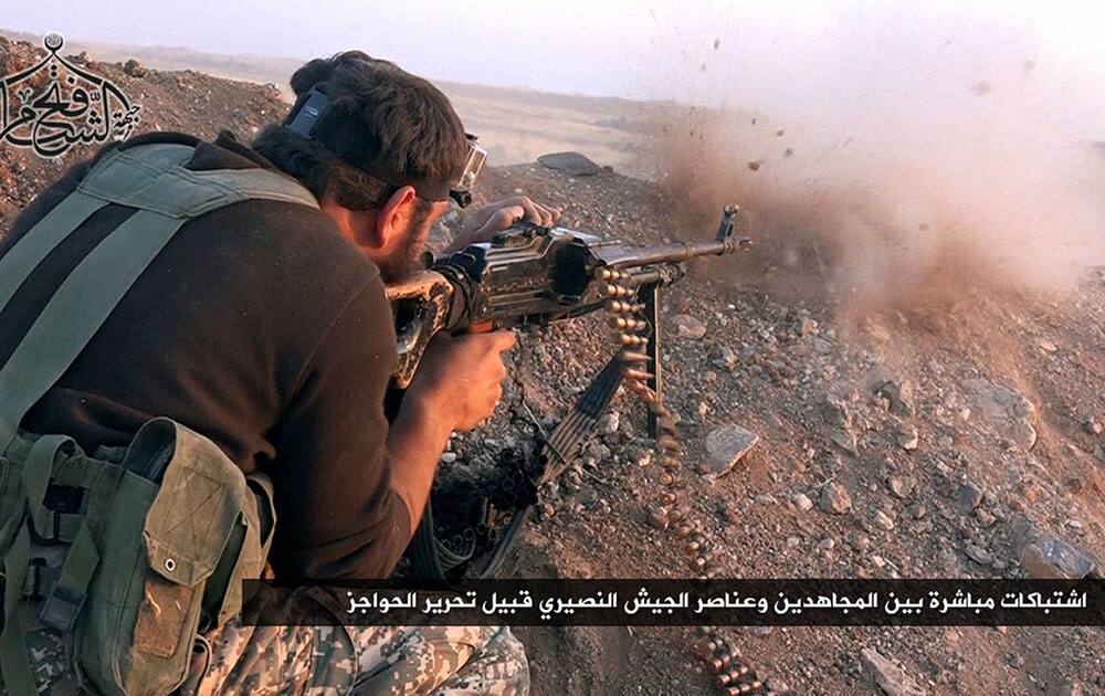 An anti-government militant group, shows a militant from the Fath al-Sham group shooting during clashes with Syrian army soldiers An anti-government militant group, shows a militant from the Fath al-Sham group shooting during clashes with Syrian army soldiers