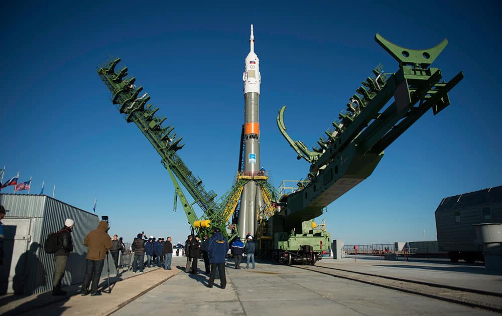 The gantry arms are raised around the Soyuz MS-02 spacecraft after it was raised into a vertical position on the launch pad