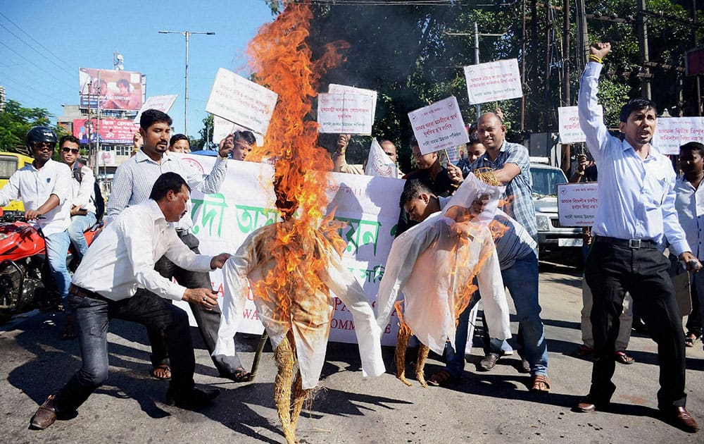 Activists of the All Assam Unnayan Parishad (AAUP) burn effigies of Prime Minister Narendra Modi