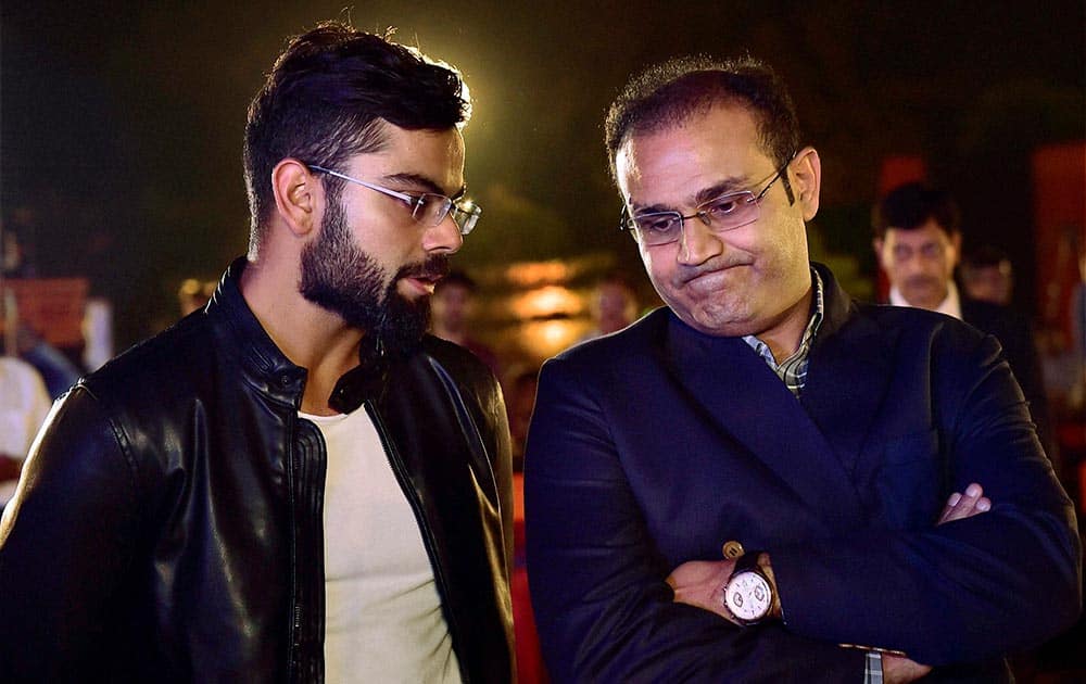 Virat Kohli and former team mate Virender Sehwag