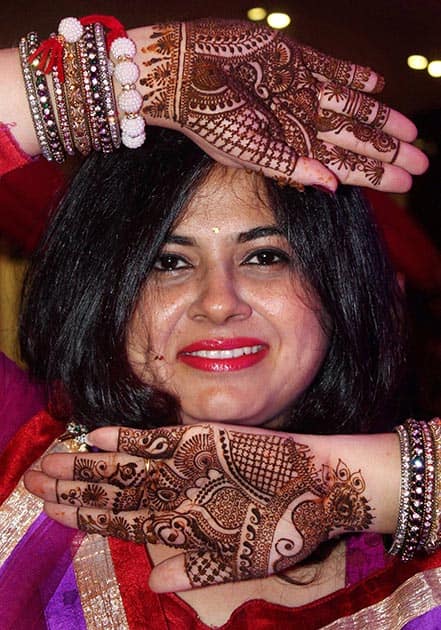 A woman shows the freshly applied Henna (Mehandi)