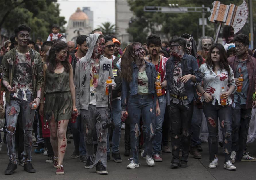 People dressed in rags and ghoulish makeup