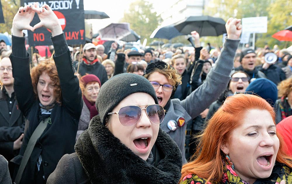 Protesters shout slogans during a rally in front of the parliament in Warsaw