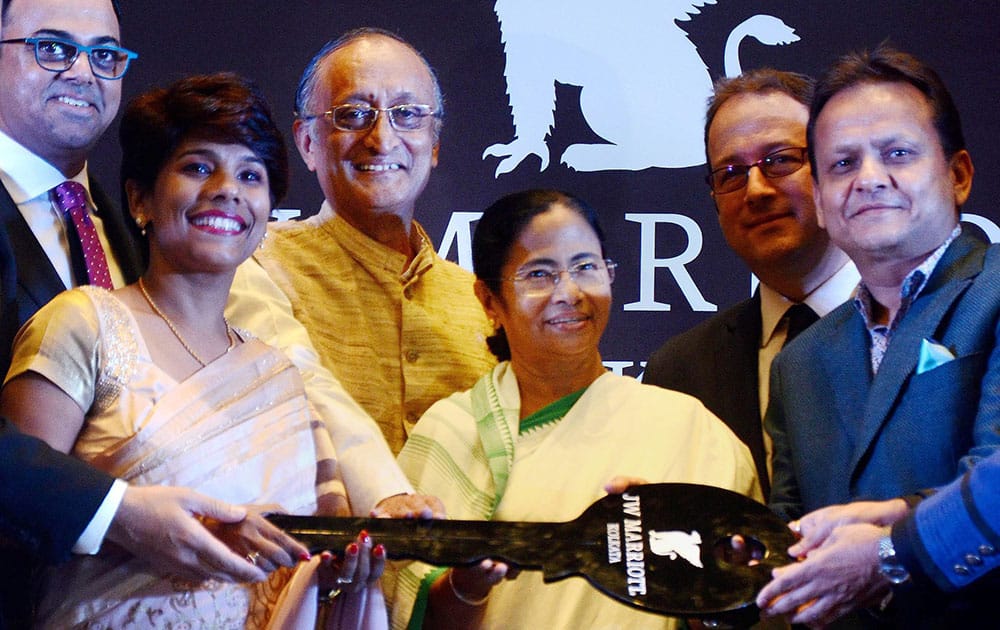 West Bengal Chief Minister Mamata Banerjee holds a symbolic key at the inauguration of JW Marriots hotel in Kolkata