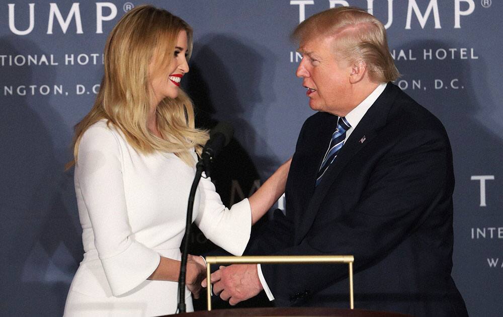 Donald Trump greets his daughter Ivanka Trump during the grand opening of Trump International Hotel