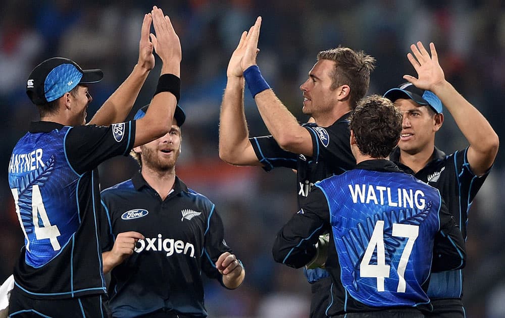 New Zealand bowler T Southee jubiliates with teammates after dismissing Indian batsman Manish Pandey