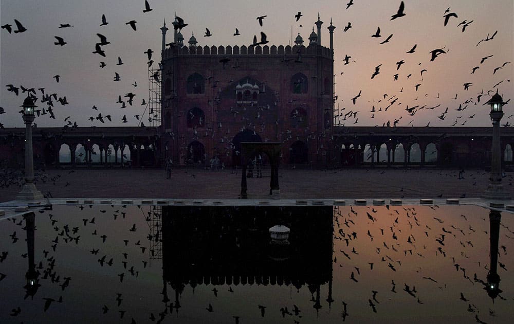 Jama Masjid is reflected in the pond