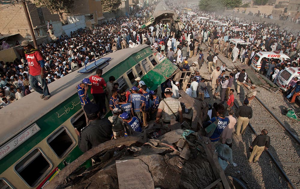 People look for victims in the wreckage of the trains in Karachi, Pakistan