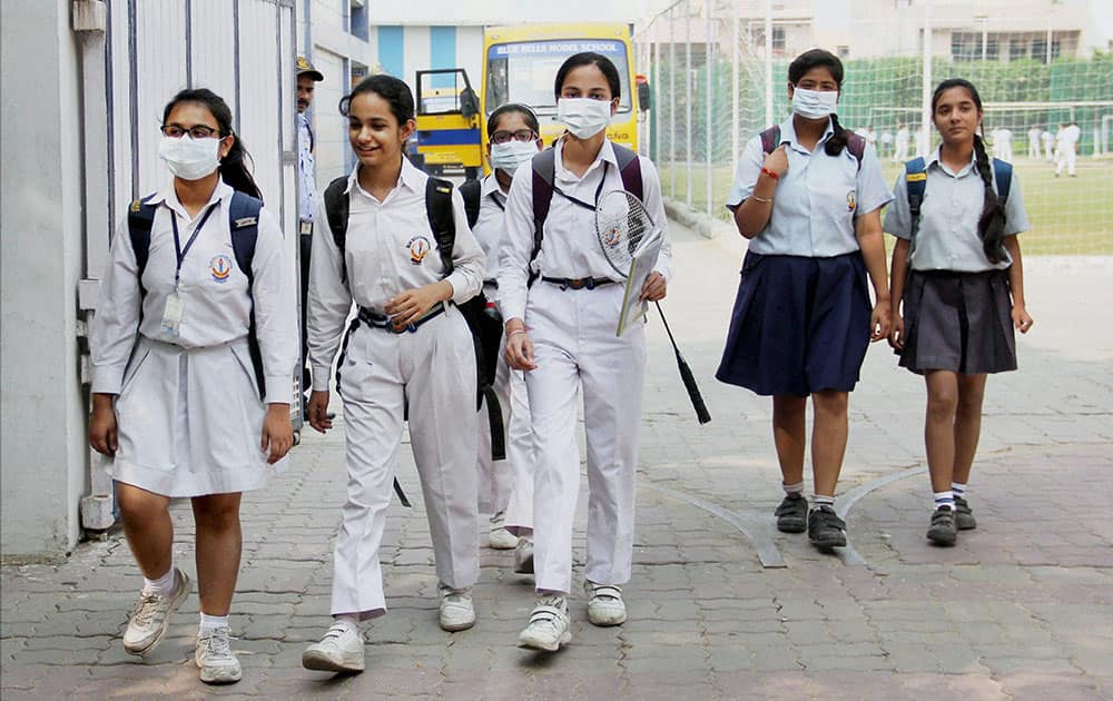School girls wear anti-air pollution mask as a protective gear as pollution reached hazardous levels in Gurgaon