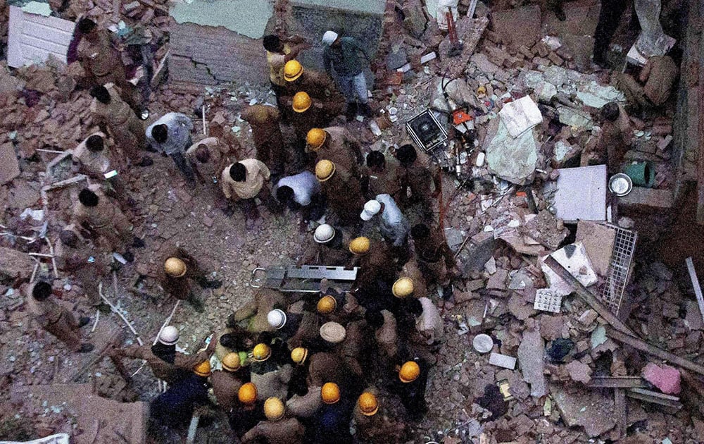 Fire personnel carry out rescue work after a four-storey building collapsed in Azad Market in Delhi
