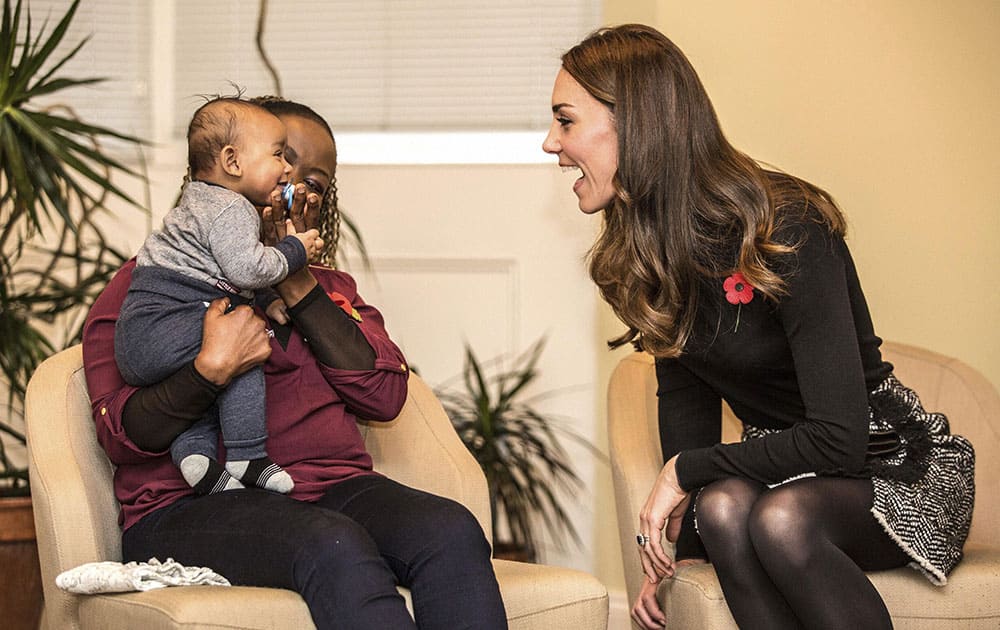 Britains Kate, Duchess of Cambridge talks to Hlengiwe Sithole and her 4 month old son Gabriel