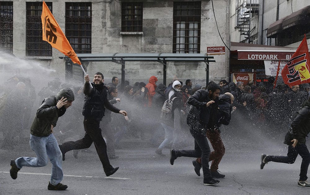 Riot police use water cannons to disperse people protesting the detentions