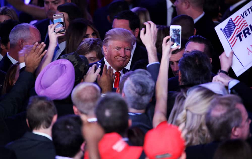 Republican president-elect Donald Trump greets people in the crowd