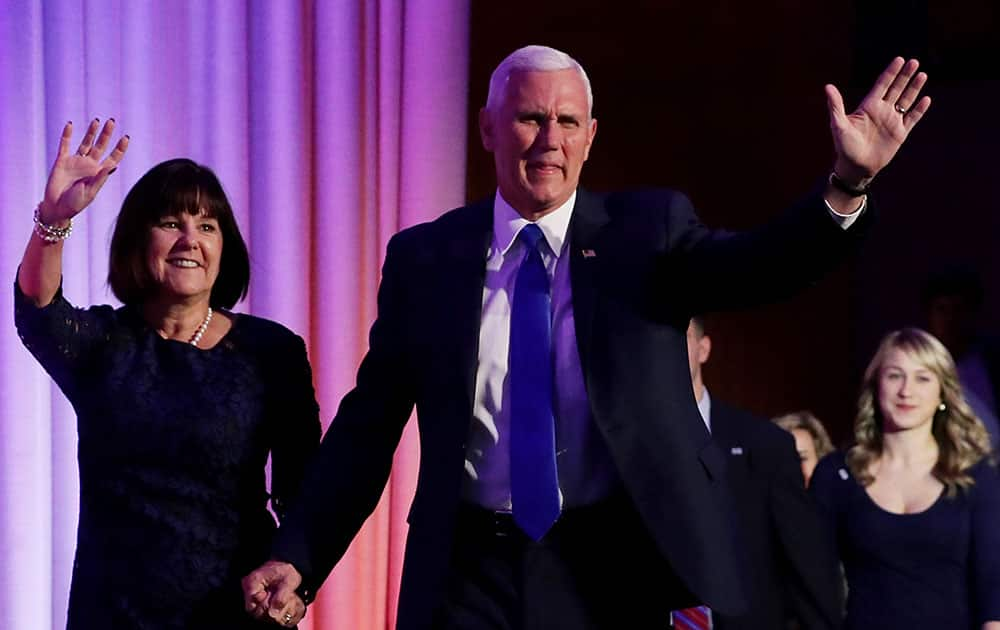 Vice president-elect Mike Pence walks on stage with his wife Karen Pence