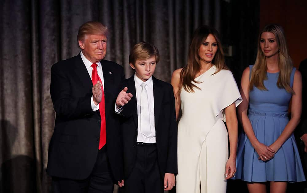 Republican president-elect Donald Trump, his son Barron Trump, wife Melania Trump, and daughter Ivanka Trump acknowledges the crowd